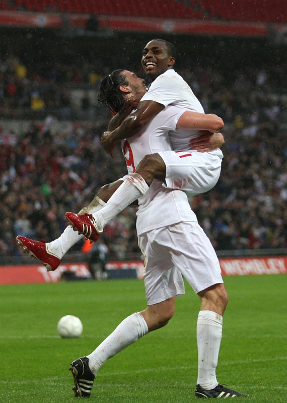 Andy Carroll celebrates with Danny Rose after the midfielder scores against Portugal